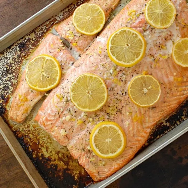 Baked Salmon with Lemon-Dill Sauce on a baking sheet, hot from the oven
