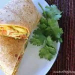 Closeup of a sliced Tomato & Mango Chicken Salad Wrap