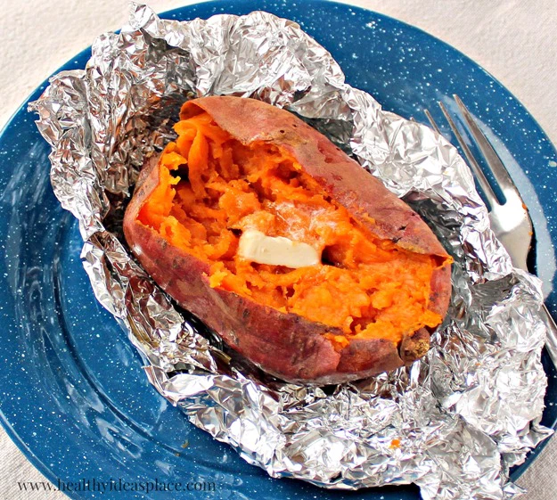 baked sweet potato on foil on blue plate