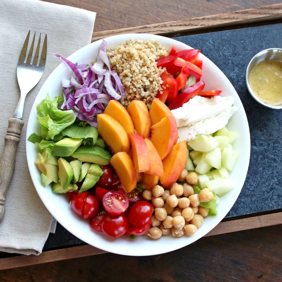 Summer Salad Bowl with Peach Basil Vinaigrette on a serving tray