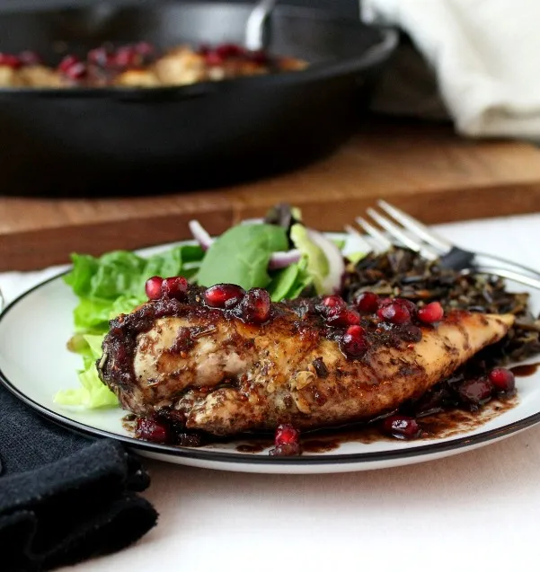 Pomegranate-Cranberry Chicken - Tender cooked chicken breasts topped with a sweet and spicy pomegranate-cranberry sauce with just the right touch of heat.