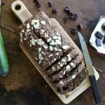 overhead view of a partially cut loaf of Zucchini Bread with Dark Chocolate and Dried Cherries