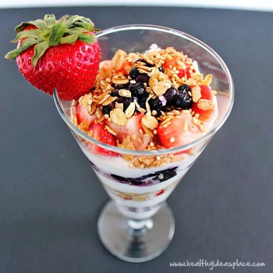 Triple-Berry Greek Yogurt Parfait in a tall glass from above