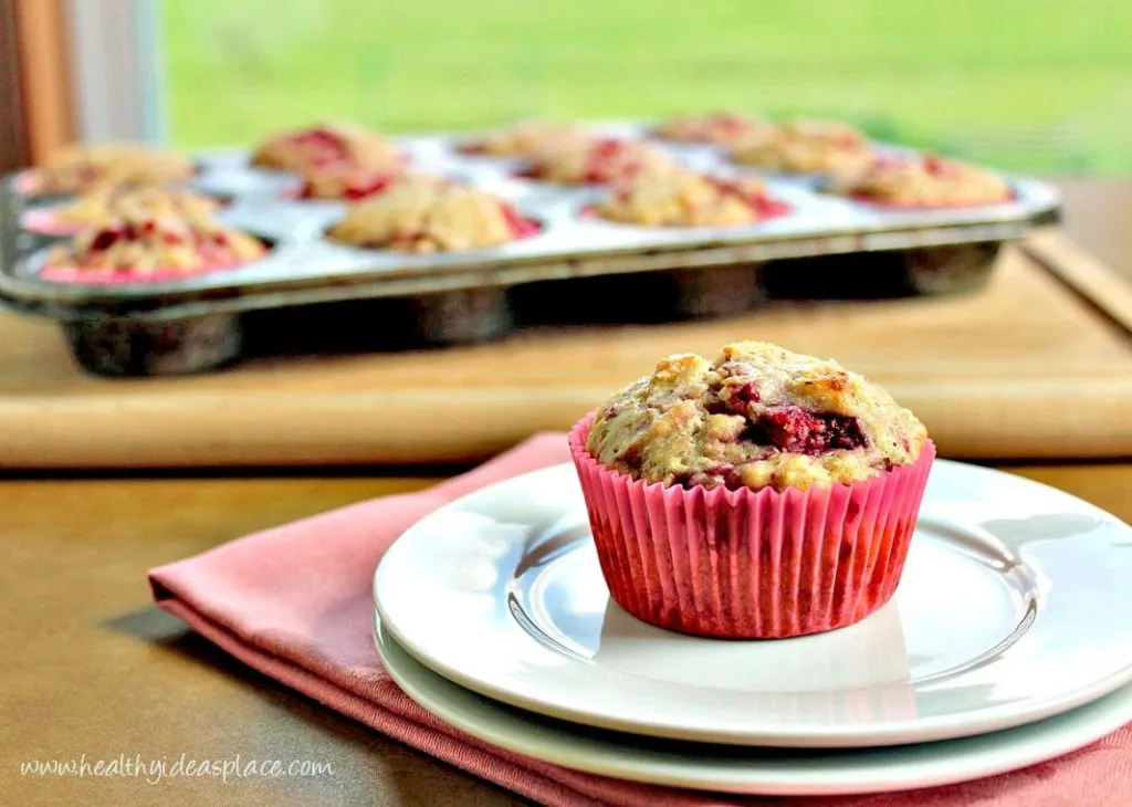 Raspberry Muffins - A summertime treat filled to the brim with sweet raspberries, a hint of lemon, and nourishing whole grains.