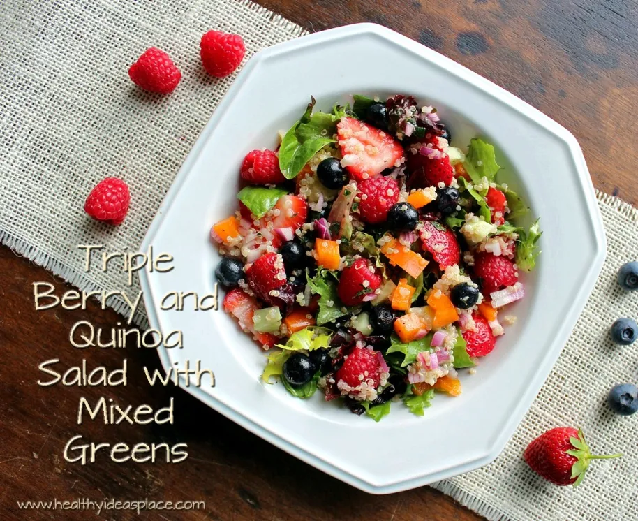 Triple Berry and Quinoa Salad with Mixed Greens places sweet berries and nutty quinoa amidst a backdrop of earthy mixed greens, cucumbers, and peppers, all pulled together with a balsamic vinaigrette for a colorful and scrumptious salad.