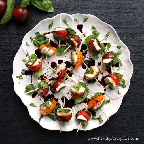 Overhead photo of Caprese Bites with Balsamic Drizzle on a white plate