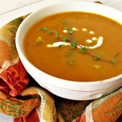 Closeup of a white bowl full of Butternut Squash Soup with White Beans and Broccoli