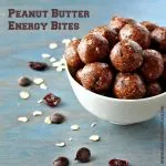 Peanut Butter Energy Bites in a white bowl on a blue bakground