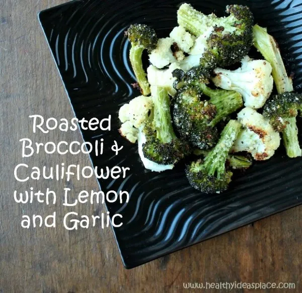 Broccoli and Cauliflower on a black plate with the words 