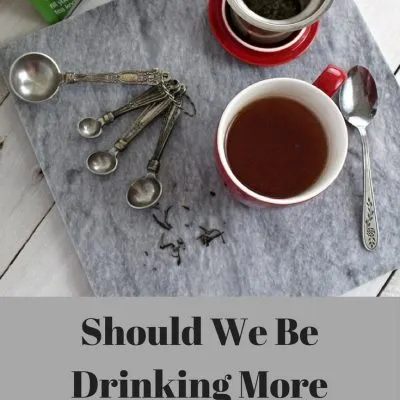 Overhead view of a red cup of tea on a marble slab