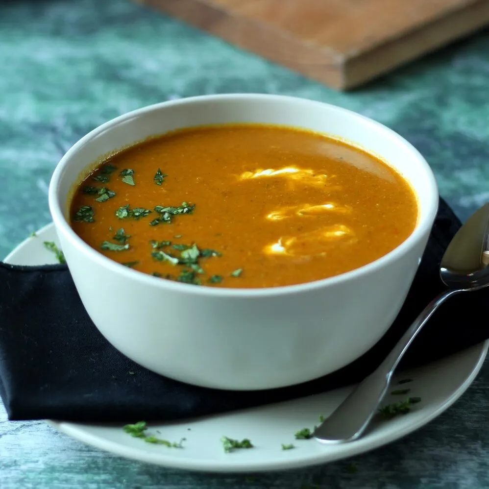 Red Lentil Soup in grey bowl on a white plate