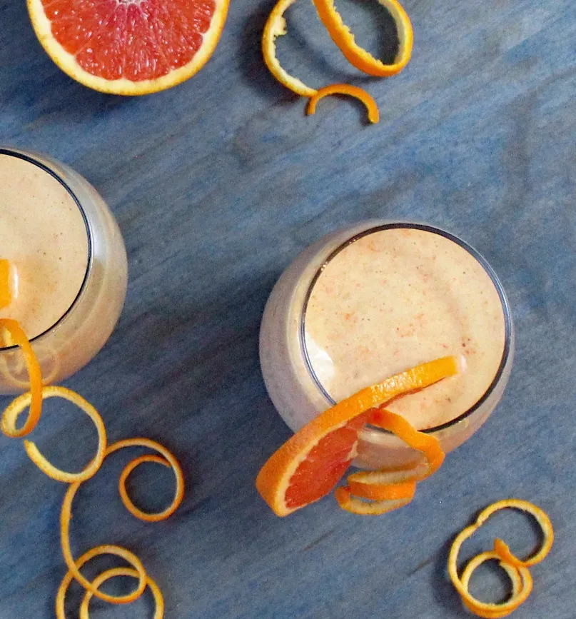 Orange and Carrot Smoothie with Ginger and Turmeric - This healthy orange and carrot smoothie is blended with ginger and turmeric for an immune boosting, creamy, and delicious smoothie. Just right for a nourishing breakfast or snack.