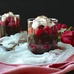 Closeup of Dark Chocolate Chia Seed Pudding with Raspberries in a clear glass
