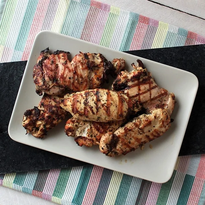 Lemon and Herb Marinated Chicken - Tender and juicy grilled chicken seasoned with lemon and herbs makes a healthy, bright, flavorful main dish that the whole family will love. Quick and easy to make too!