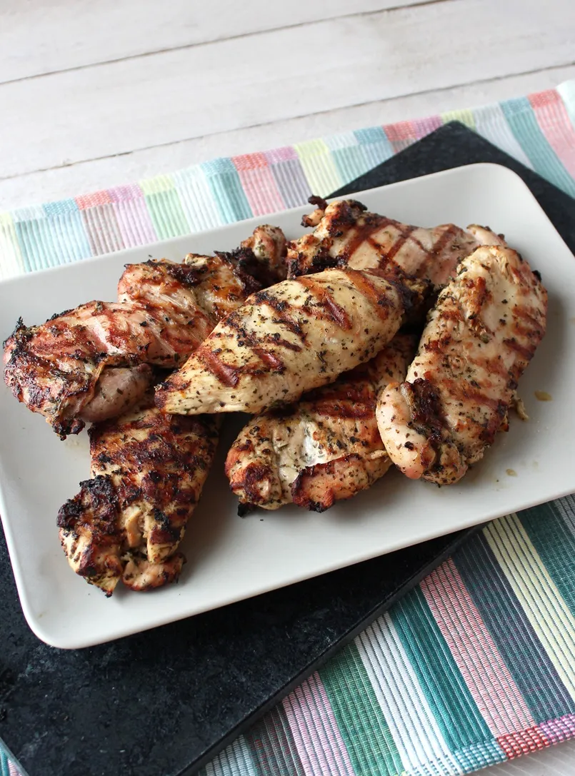 Lemon and Herb Marinated Chicken - Tender and juicy grilled chicken seasoned with lemon and herbs makes a healthy, bright, flavorful main dish that the whole family will love. Quick and easy to make too!