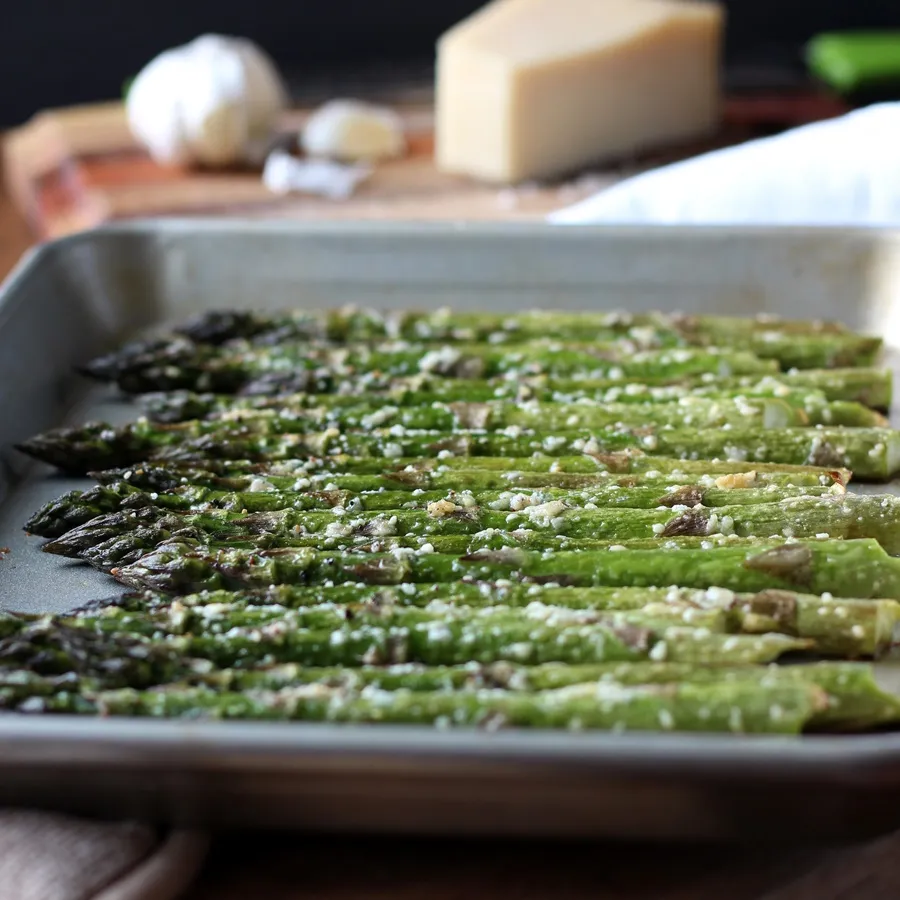 Roasted Asparagus with Parmesan and Garlic – So easy to make for dinner! Fresh asparagus is roasted until tender and seasoned with parmesan and garlic. Simple and delicious recipe!