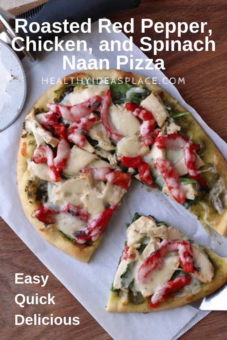 Roasted Red Pepper Chicken and Spinach Naan Pizza on cutting board with one slice cut out