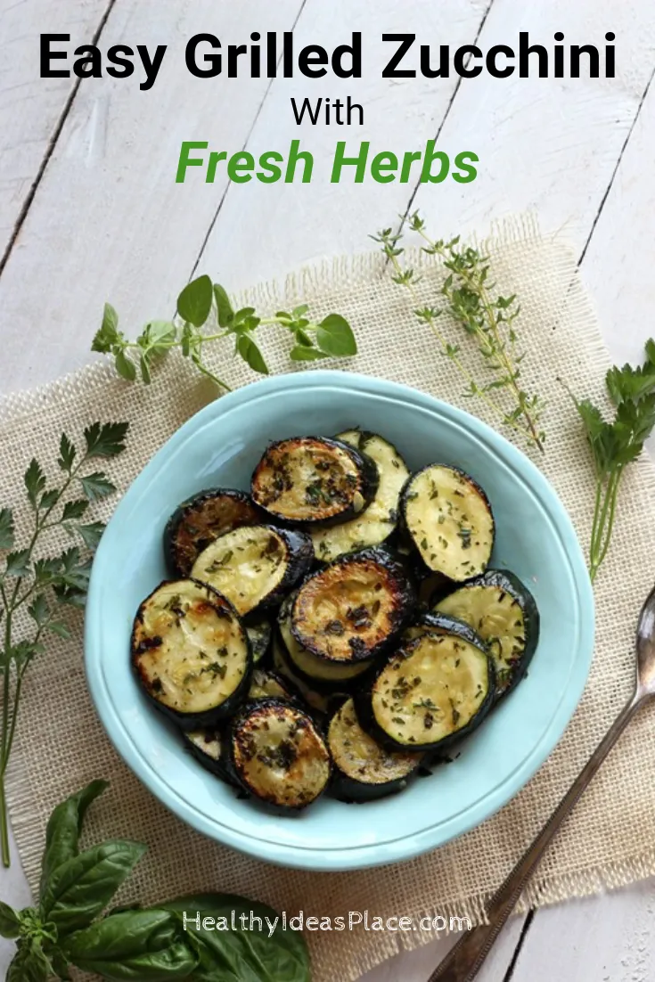 grilled zucchini slices in teal bowl on white background