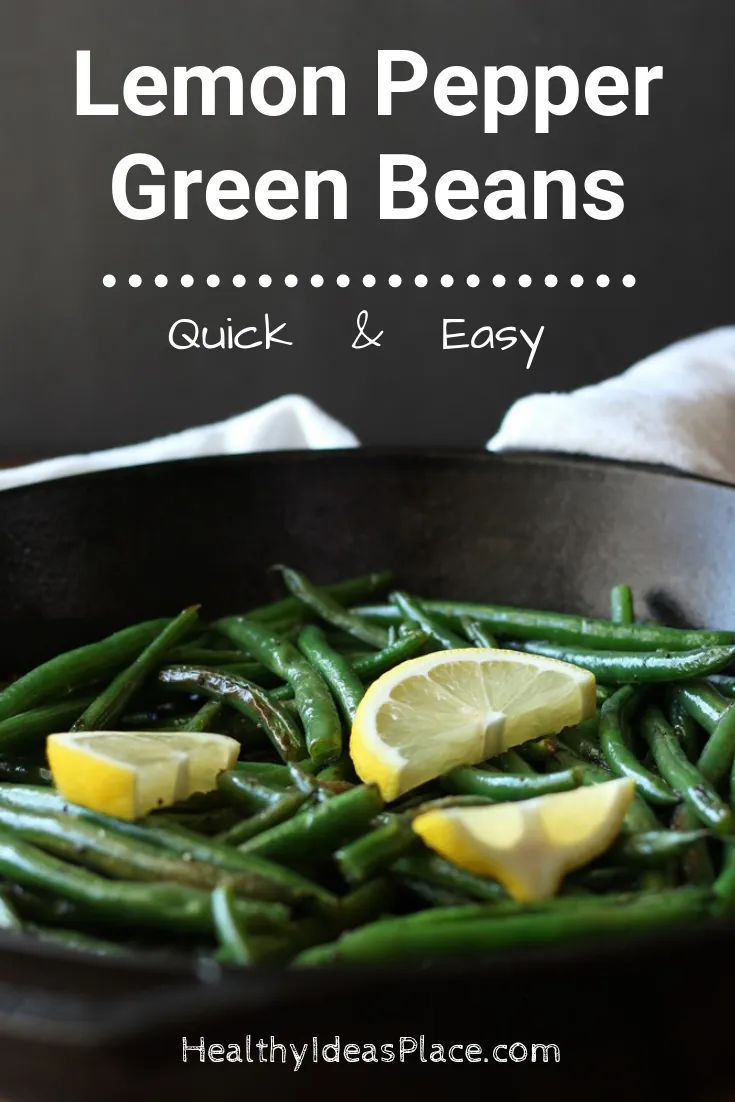 green beans and lemon slices in skillet with dark background