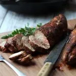 sliced pork tenderloin on cutting board