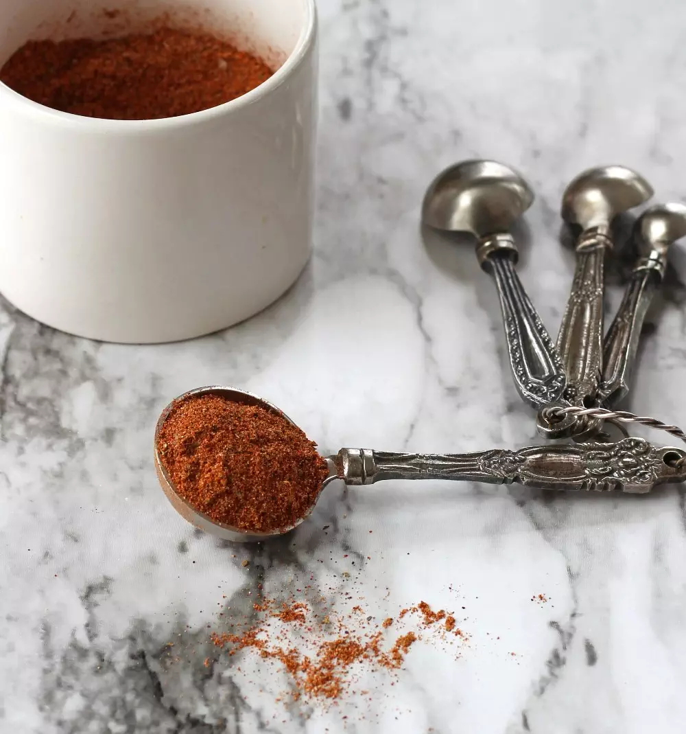 Southwest seasoning in a tablespoon on a marble background