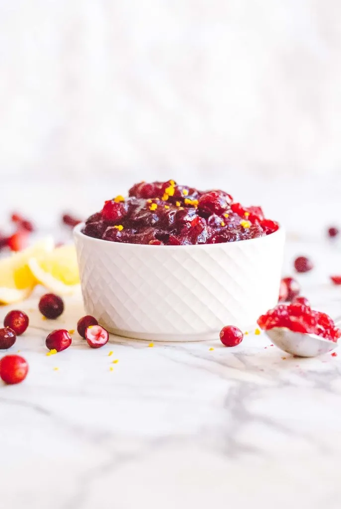 Cranberry sauce in white bowl against white background