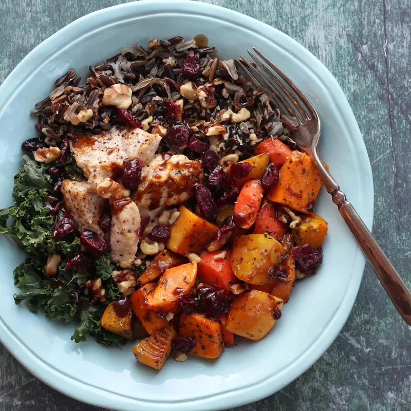 Rice, winter vegetables, kale, and chicken in teal bowl