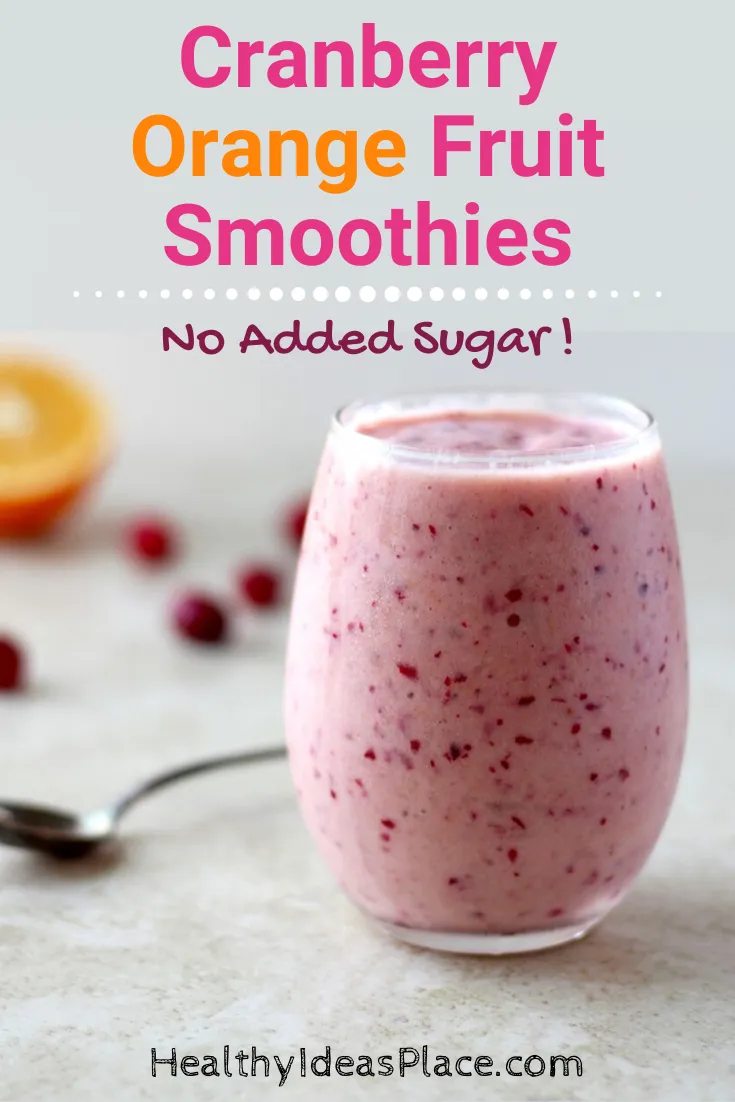 Orange and cranberry smoothie in a clear glass against a white background
