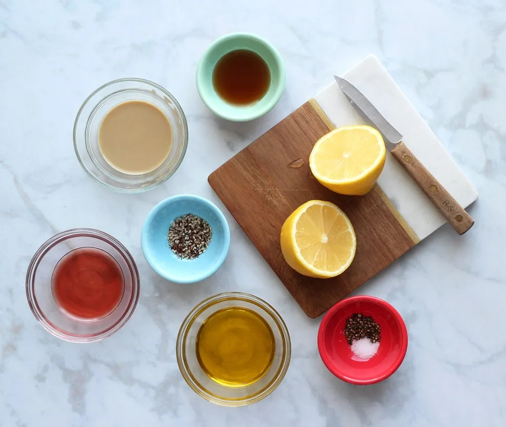 cut lemon on cutting board surrounded by bowls