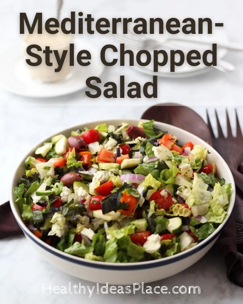 Chopped salad in a white bowl against a white background