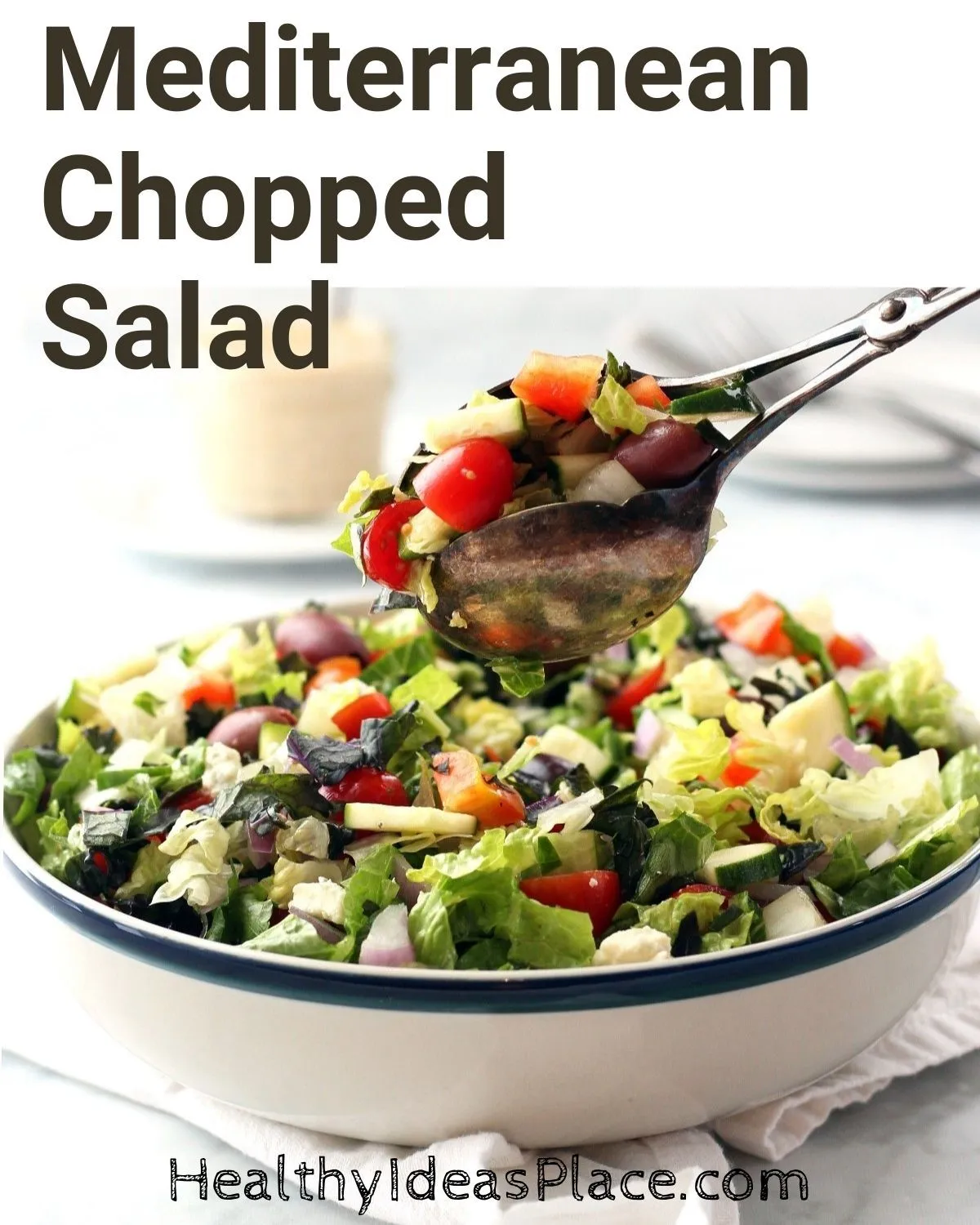 Serving of salad being lifted out of a bowl using salad tongs