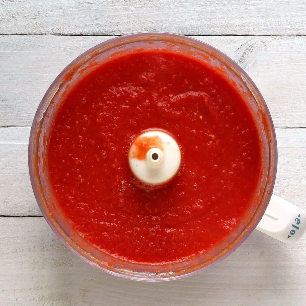 Blended cooked tomatoes in food processor looking down