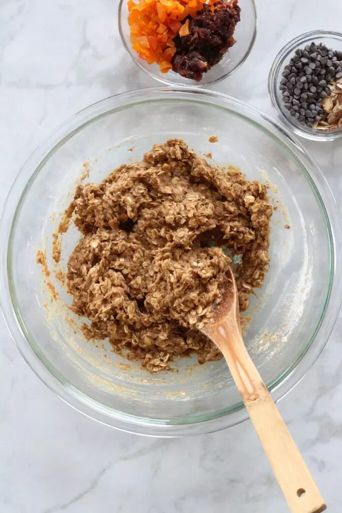 Raw breakfast cookie dough with mix-ins nearby
