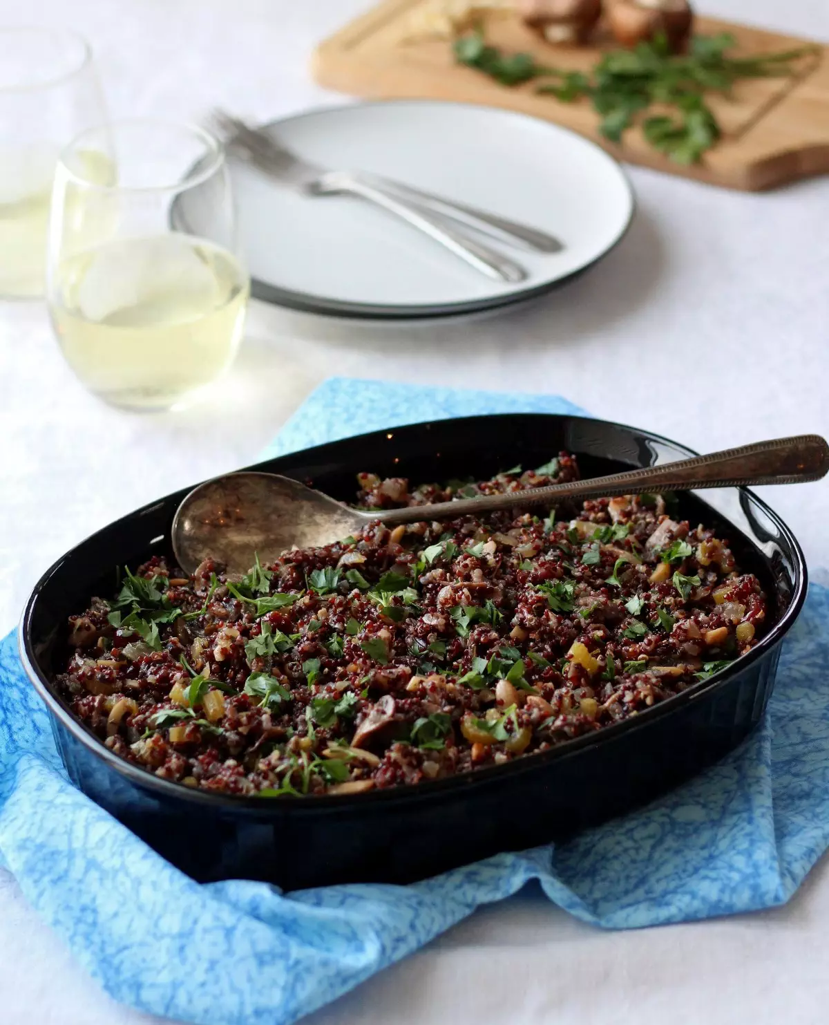 gluten free stuffing in black dish on blue fabric against white background