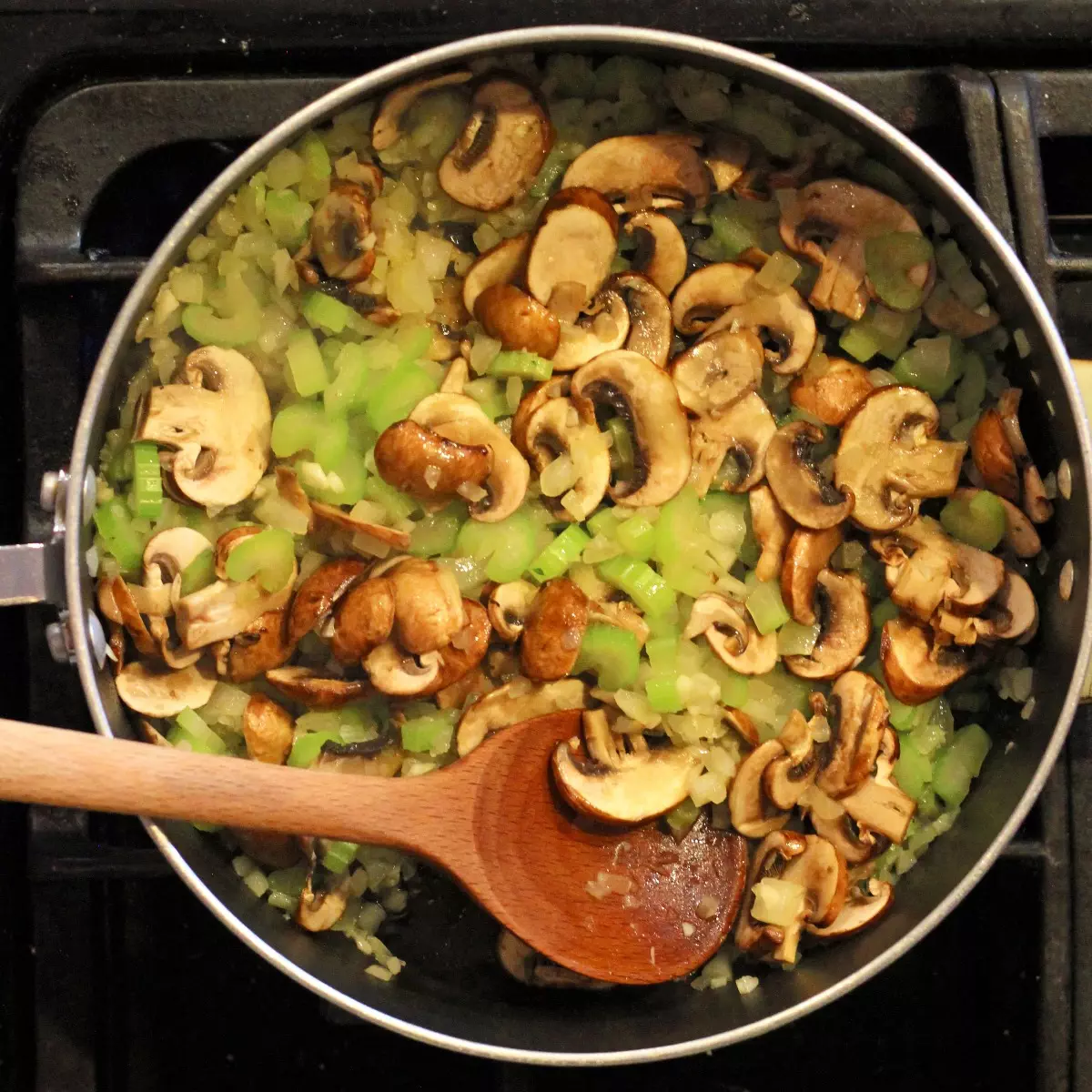 Onion, celery, and mushrooms sauteed in pan
